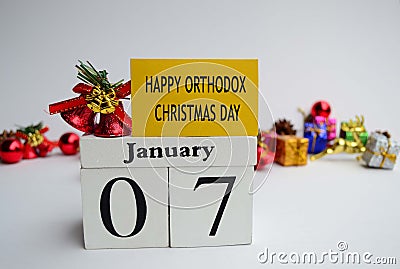 Text label and cube 7th January with blurred christmas ornament background, Happy Orthodox Christmas Day Stock Photo