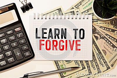 Text Learn to Forgive written with golden letters on a red heart Stock Photo