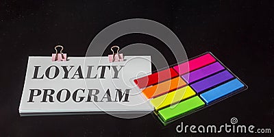 The text Loyalty program is written on a sticker, next to the colored stickers Stock Photo