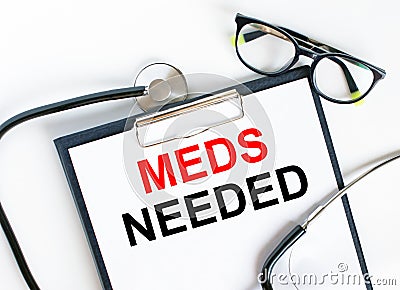 Text Meds Needed in the folder with the stethoscope and glasses Stock Photo