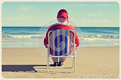 Text merry christmas and santa claus on the beach Stock Photo