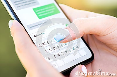 Text message with mobile phone. Woman texting sms with smartphone Catfish or digital scam. Screen keyboard in instant messaging. Stock Photo