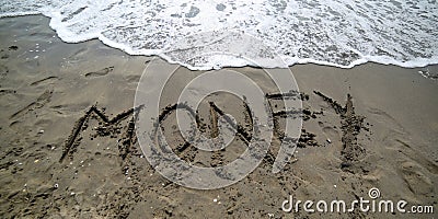 text MONEY on the sand of the sea Stock Photo