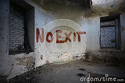 Text no exit on the dirty old wall in an abandoned ruined house Stock Photo