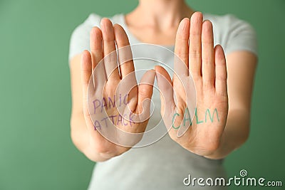 Text PANIC ATTACK and CALM written on woman's palms, closeup Stock Photo