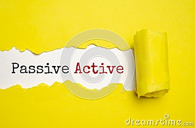 Text Passive Active appearing behind torn brown paper Stock Photo