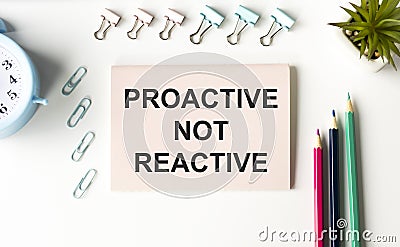 Text Proactive not reactive on white paper book Stock Photo