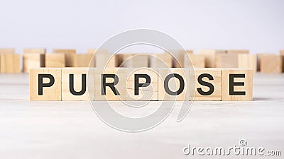 text PURPOSE on wooden cubes on bright grey background. square wood blocks. top view, flat Stock Photo