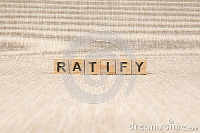 text Ratify on wood cube block, stock concept. the text benefit is written on the cubes in black letters, the cubes are Stock Photo
