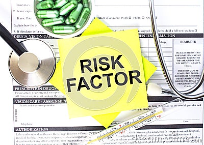 Text Risk Factor in a notebook on medical forms with a phonendoscope and green pills Stock Photo