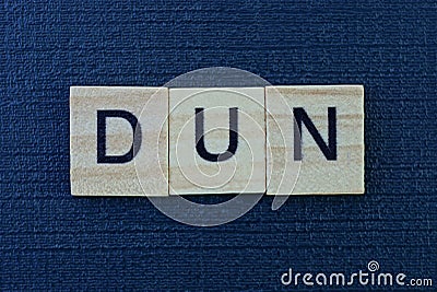 Text from the short word dun from gray wooden letters Stock Photo