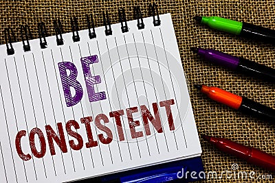 Text sign showing Be Consistent. Conceptual photo Uniform Persistent Firm Unalterable Even Unchanging Rapport Open spiral notebook Stock Photo
