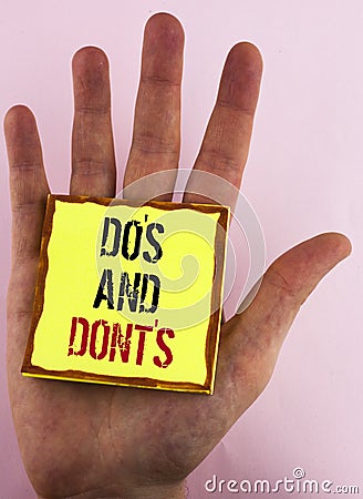 Text sign showing Do'S And Don'Ts. Conceptual photo What can be done and what cannot be knowing right wrong written on Yellow St Stock Photo