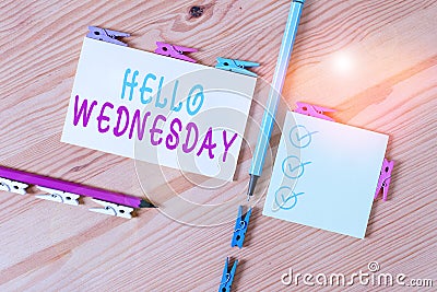 Text sign showing Hello Wednesday. Conceptual photo Hump day Middle of the working week of the calendar Colored clothespin papers Stock Photo