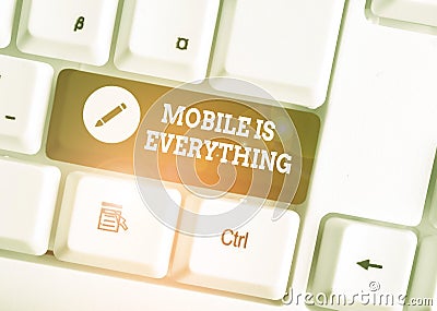 Text sign showing Mobile Is Everything. Conceptual photo Handheld Computer Device a Planner Wallet Organizer White pc keyboard Stock Photo