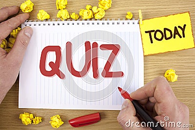 Text sign showing Quiz. Conceptual photo Short Tests Evaluation Examination to quantify your knowledge written by Man on Notepad h Stock Photo