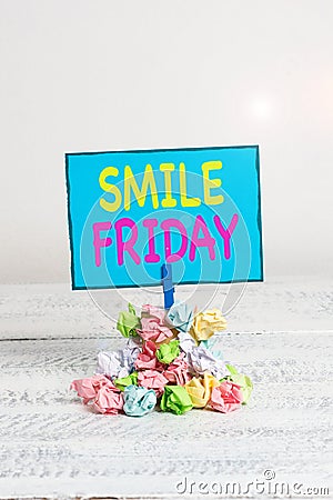 Text sign showing Smile Friday. Conceptual photo used to express happiness from beginning of fresh week Reminder pile Stock Photo