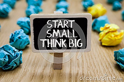 Text sign showing Start Small Think Big. Conceptual photo Initiate with few things have something great in mind Paperclip hold wri Stock Photo