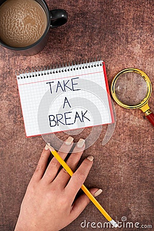 Text sign showing Take A Break. Business approach Resting Stop doing something recreation time get out of work Hand Of Stock Photo