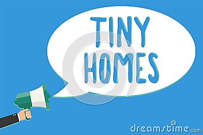 Text sign showing Tiny Homes. Conceptual photo houses contain one room only or two and small entrance Cheap Man holding megaphone Stock Photo