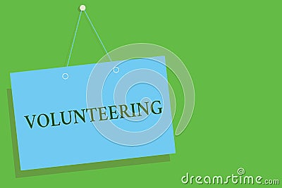 Text sign showing Volunteering. Conceptual photo Provide services for no financial gain Willingly Oblige Blue board wall message c Stock Photo