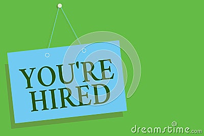 Text sign showing You re are Hired. Conceptual photo New Job Employed Newbie Enlisted Accepted Recruited Blue board wall message c Stock Photo