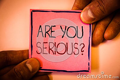 Text sign showing Are You Serious Question. Conceptual photo Have to be kidding me Disbelief Is it for real Man hold holding pink Stock Photo