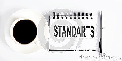 Text STANDARTS , planning concept. notebook with text on white background with coffee Stock Photo