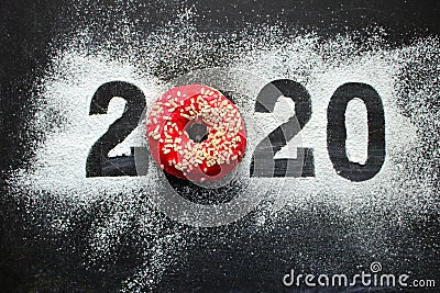 Text 2020 surrounded by colorful donuts on a black background vintage, new year concept. Stock Photo