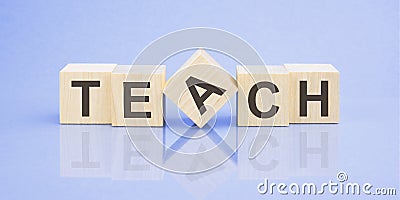 text TEACH on wooden cubes. bright blue surface Stock Photo