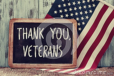 Text thank you veterans in a chalkboard and the flag of the US Stock Photo