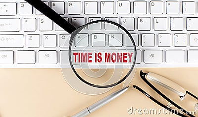 Text TIME IS MONEY on keyboard with magnifier , glasses and pen on beige background Stock Photo