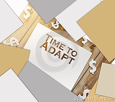 text Time to Adapt page, paper signs of dollar on wood table. Business concept Stock Photo