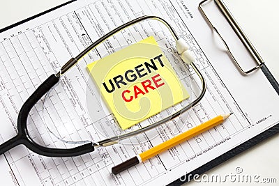 Text Urgent Care on a yellow sticker with a stethoscope lying on a folder with medical documents Stock Photo