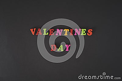 Text Valentines day by colorful letters on black background. Stock Photo