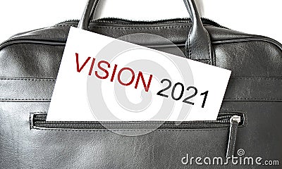 Text vision 2021 writing on white paper sheet in the black business bag. Business concept Stock Photo