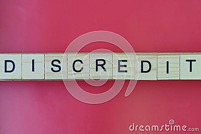 Text the word discredit from gray wooden small letters Stock Photo