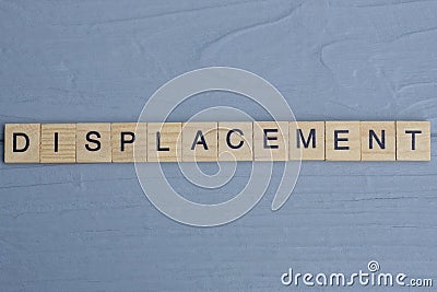 text the word displacement from brown wooden small letters Stock Photo