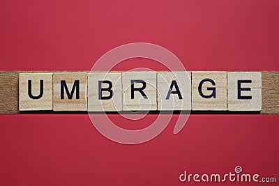 Text the word umbrage from gray wooden small letters Stock Photo