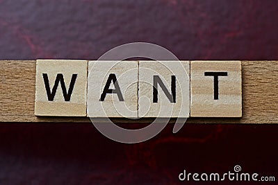 Text the word want from gray wooden small letters Stock Photo
