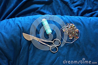 Textile background with sewing scissors, needles and threads Stock Photo