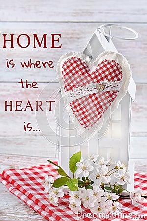 Textile heart hanging on white metal house decor and the inscription with sentence Stock Photo