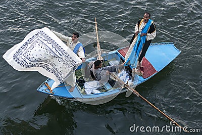 Textile salesmen in their rowing boat near the Esna Lock on the River Nile in Egypt. Editorial Stock Photo