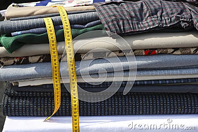 Textiles fabrick stacked yellow meter tape Stock Photo