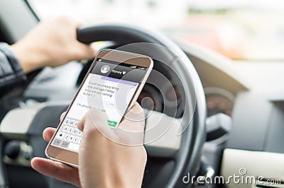 Texting while driving car. Irresponsible man sending sms. Stock Photo