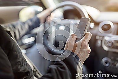 Texting while driving using cell phone in car Stock Photo
