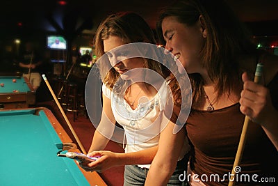 Texting at the pool hall Stock Photo