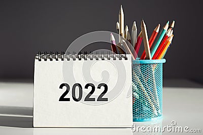 2022 texton the notepad and blue pencil holder on gray background Stock Photo