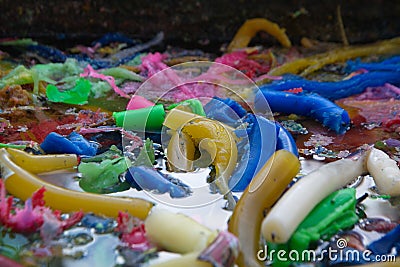Texture and background of colorful candles that had burned as a result of worship floated in a tub of water. Stock Photo