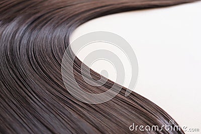 texture of beautiful glossy long hair.Curl female healthy hair. Concept hairdresser spa salon. strand of brunette silky Stock Photo